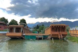 two large boats in a body of water at Vanda Heritage Houseboats in Srinagar