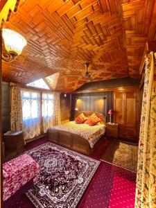 a bedroom with a bed and a wooden ceiling at Vanda Heritage Houseboats in Srinagar