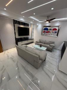 a living room with a couch and a tv at villa la pal de 4 in La Ureña