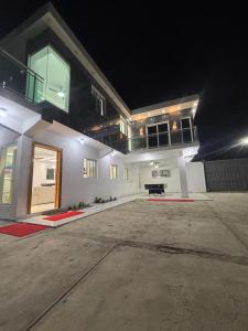 a large white house with a driveway at night at villa la pal de 4 in La Ureña