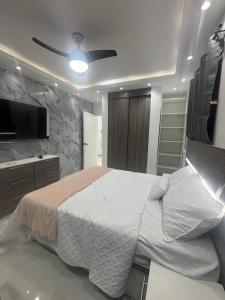 a bedroom with a bed and a ceiling fan at villa la pal de 4 in La Ureña