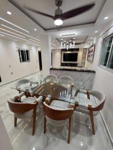 a dining room with a glass table and chairs at villa la pal de 4 in La Ureña