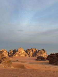 a desert scene with rocks and a blue sky at Eileen wadi rum camp in Wadi Rum +61 photos