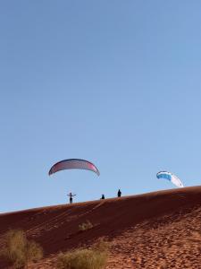 a group of paratroopers on a hill in the desert at Eileen wadi rum camp in Wadi Rum
