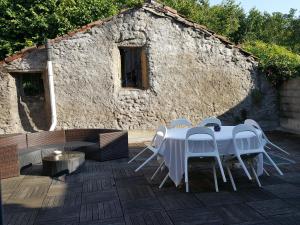 a white table and chairs in front of a building at LE Prana in Rozérieulles