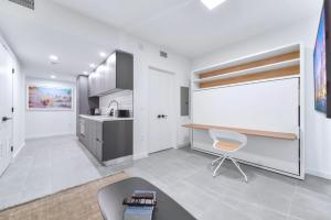 a kitchen with a desk and a chair in a room at Stylish Studio in Brickell Core in Miami