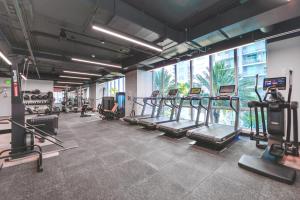 a gym with treadmills and machines in a room at Stylish Studio in Brickell Core in Miami