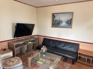a living room with a couch and a flat screen tv at Family Summer House in Valparaíso