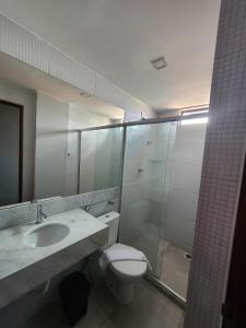 a bathroom with a toilet and a shower and a sink at Murano Suits Hotel in João Pessoa