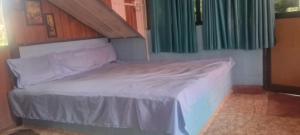 a bed in a small room with at Shree MAHAGANAPATI ROOMS 6 bed room only for gents in Gokarna