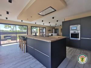 a kitchen with a large island in the middle at La villa manon in Florensac