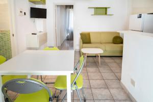 a living room with a couch and a table and chairs at M377 - Marcelli, bilocale con corte esterna e posto auto in Marcelli