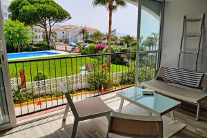 een woonkamer met een tafel en stoelen en een groot raam bij Neenies Nerja - Carabeo Luxury Apartment in Nerja