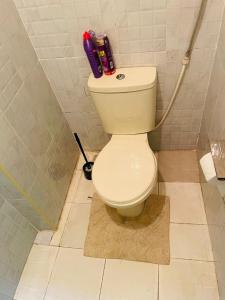 een badkamer met een toilet in de hoek van een kamer bij Le Comfort in Eldoret