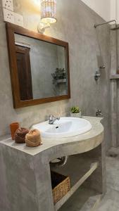 a bathroom with a sink and a mirror at Kataragama Homestay in Kataragama +49 photos