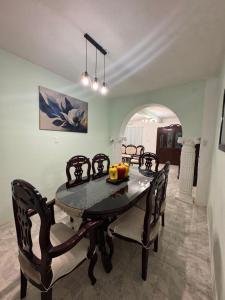 a dining room with a black table and chairs at Casa X-lapac in Valladolid