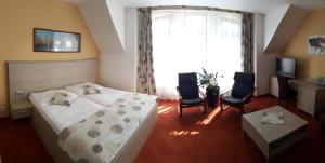 Llit o llits en una habitació de Hotel Vinarsky Dom