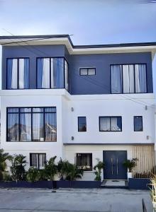 a blue and white house with plants in front of it at EB Home Apartment in Mactan Island +3 photos