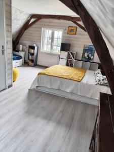 a bedroom with a bed in a attic at Le Jardin des Oiseaux in Saint-Michel-sur-Loire