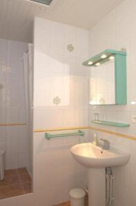 une salle de bain blanche avec un lavabo et des toilettes dans l'établissement Bouton d or, à Bolquère-Pyrénées 2000