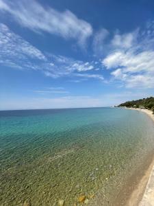 a view of a beach with a blue sky and water at Zoel's House in Chalkidiki in Agia Paraskevi