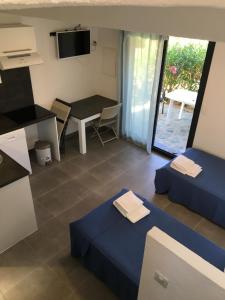 a room with two beds and a table at Bellavistaloc' in Porto-Vecchio