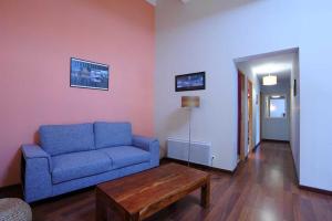 a living room with a blue couch and a coffee table at Cecile in Montgaillard