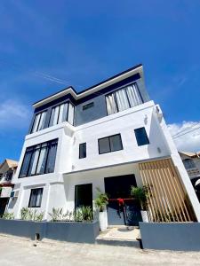 a white building with a lot of windows at EB Home Apartment in Mactan Island