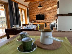 a table with two coffee cups on a table at Iža na brejgi in Moravske-Toplice