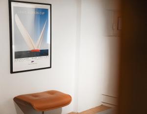 a brown stool sitting next to a picture on a wall at Charming Historical Apartment in Zurich City Center Oldtown in Zurich