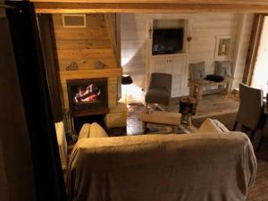 a living room with a fireplace in a house at Cal xiquet in Bolquere Pyrenees 2000