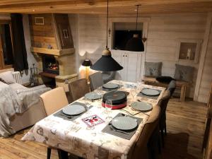 a dining room with a table and chairs and a fireplace at Cal xiquet in Bolquere Pyrenees 2000 +15 photos
