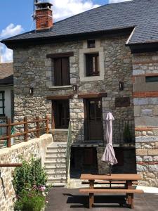a building with a bench in front of it at Cal xiquet in Bolquere Pyrenees 2000