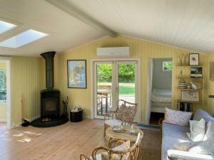 a living room with a couch and a fireplace at Summerhouse Close To Nature And Beach in Rørvig +26 photos