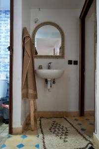 a bathroom with a sink and a mirror at tamazirt surf house in Taghazout +57 photos