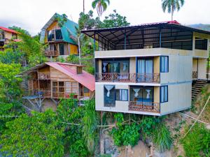 a building on top of a hill with trees at RioVida EcoLodge in Nueva Tarqui