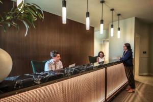 a group of people sitting at a reception desk at Landing Apartments - The 55 Elm Club in Hartford