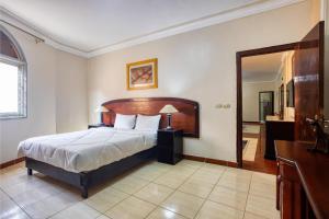 une chambre avec un grand lit et un miroir dans l'établissement Arena Hostel, à Hurghada