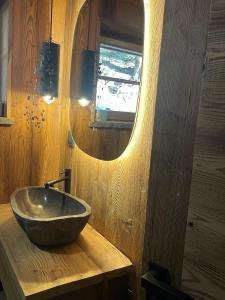 a bathroom with a bowl sink on a wooden counter at Chalet de ZORE in Morzine +45 photos