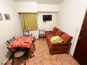 a living room with a couch and a table at Depto San Bernardo céntrico2 in San Bernardo
