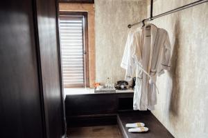 a bathroom with a robe hanging on a wall at The Wildings Northumberland in Morpeth +67 photos