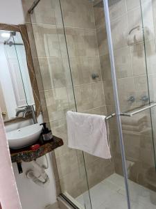 een badkamer met een douche en een wastafel bij Mahalo Hostel in Salento