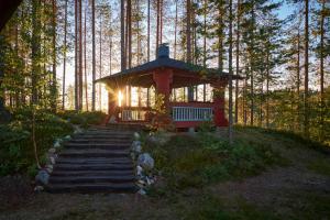 a small gazebo sitting on top of a forest at Capture Nordic Wilderness Camp - Baumzelt in Ilomantsi