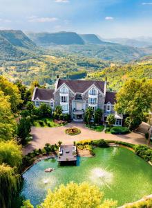 an aerial view of a house with a boat in a pond at Castelo Saint Andrews in Gramado