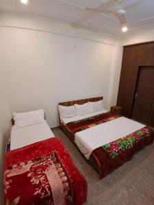 two beds sitting next to each other in a room at WoodsPicker in Rishīkesh +12 photos