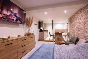 a bedroom with a bed and a brick wall at Au Spa de LLEA in Avignon