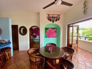 a dining room with a table and chairs at Regio - Casa MoJo's spacious 2BR, kitchen, pool in Sayulita