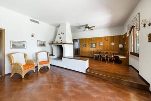 a living room with a fireplace and a dining room at Daller Bianca by Whale Homes in Soiano del Lago