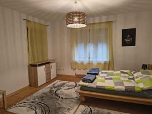a bedroom with a bed and a chandelier at Juls garden apartment in Tulln