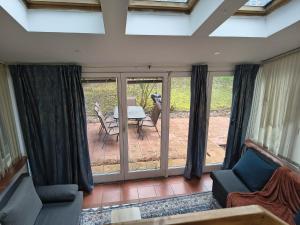 a living room with sliding glass doors and a patio at Juls garden apartment in Tulln